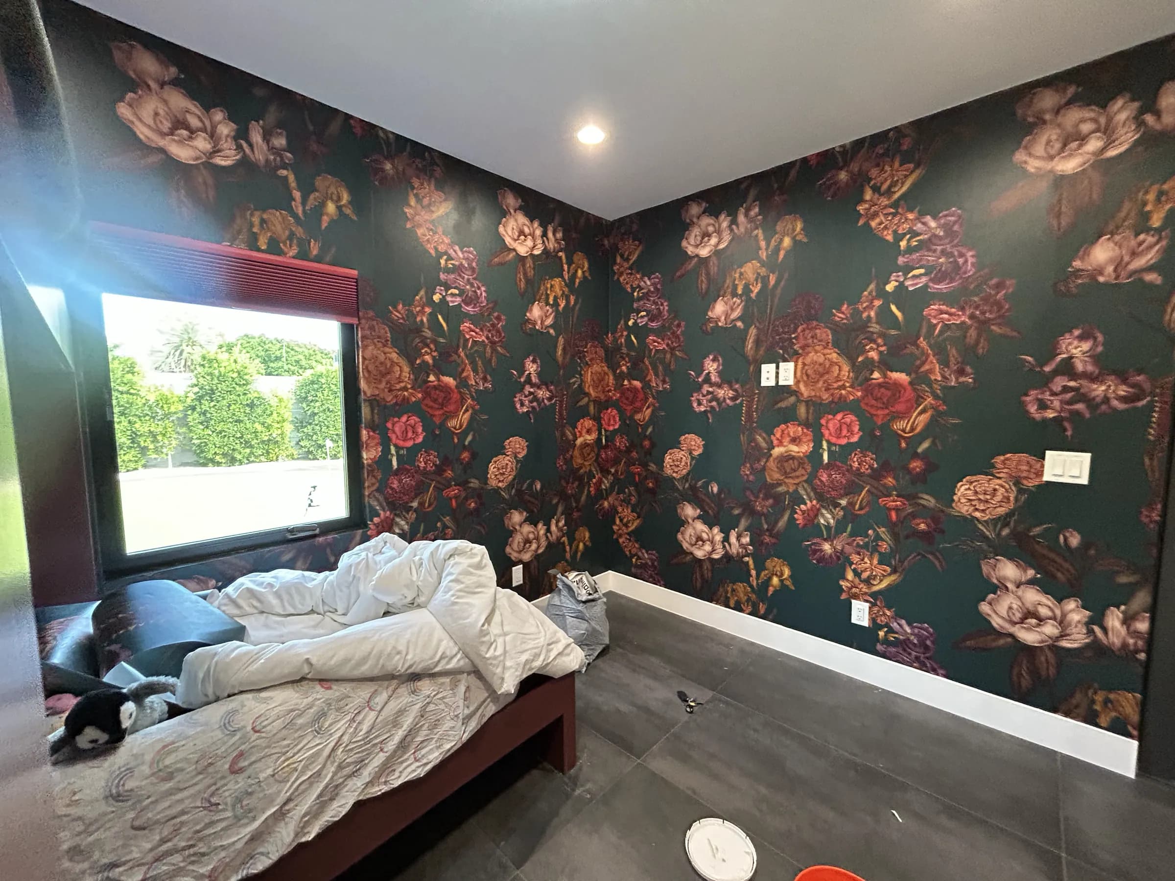 The same bedroom finished, the third wall papered to match